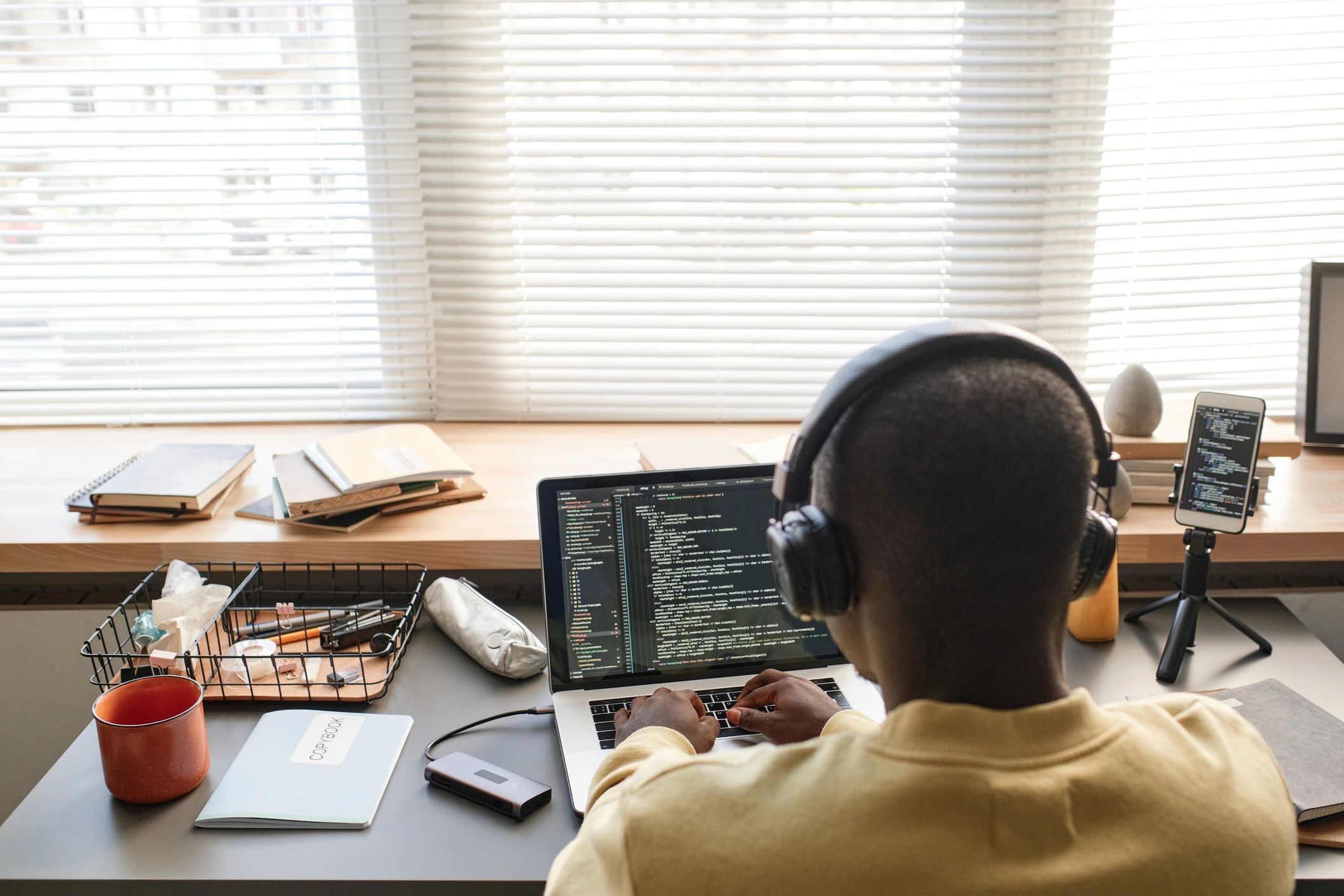 Programmer working at a laptop on code