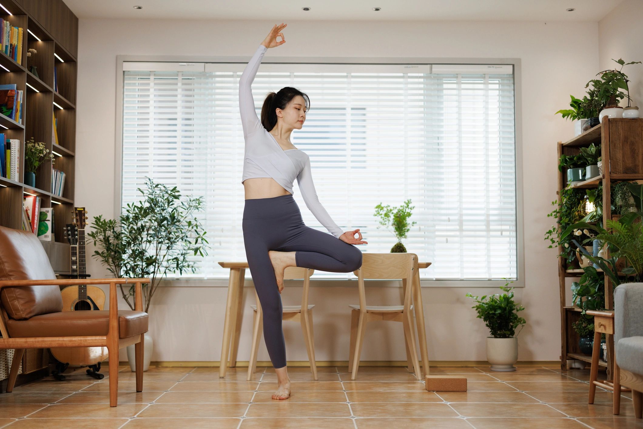 Attractive Asian woman practicing yoga in side bend pose