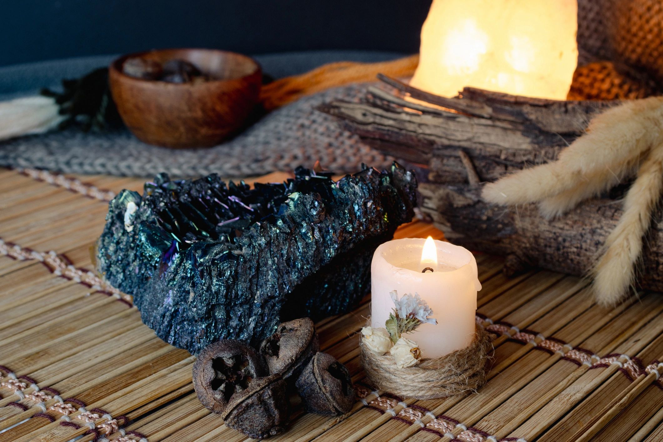 Spiritual altar with lit candle and iridescent crystal
